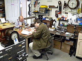 Matt More, foreground, hard at work assembling his timepiece. Tom Bowers, the store’s owner, is busy in the background.